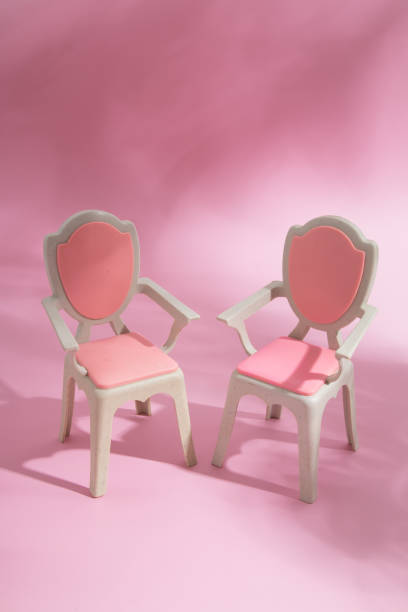 istock Abstract composition still life puppet chairs on a pink background with shadows 1388578857