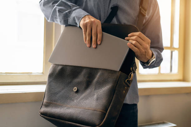 istock Unrecognizable businessman take out his digital tablet/laptop from leather briefcase 1388579093