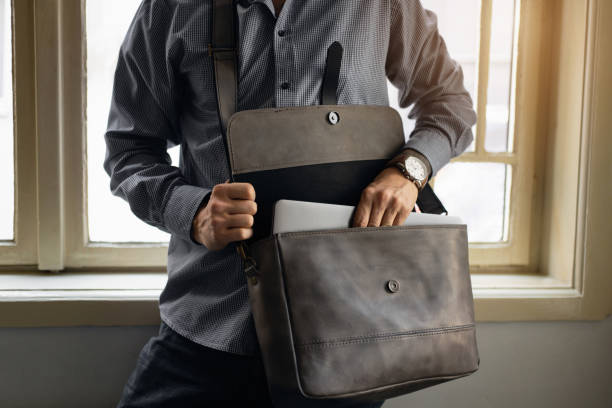 istock Unrecognizable businessman take out his laptop from briefcase 1388579215
