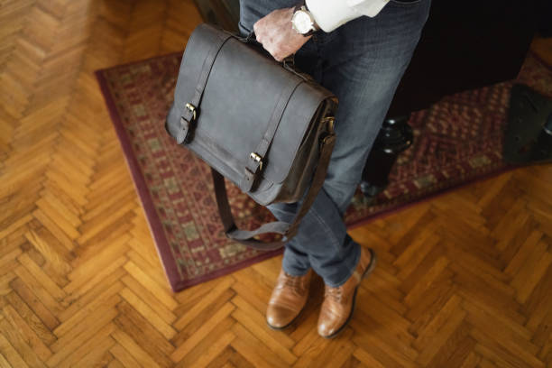 istock High angle view of unrecognizable businessman carrying leather briefcase 1388579425
