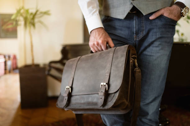 istock Fashionable unrecognizable businessman carrying leather briefcase 1388579459