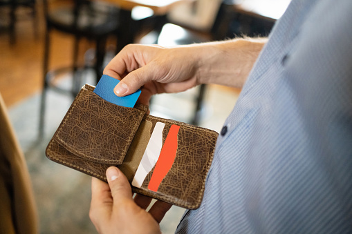 Unrecognizable Caucasian man takes out the credit card from the wallet