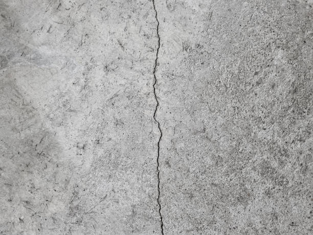 crack on a grey concrete floor, wall, surface, grey texture - crevice imagens e fotografias de stock