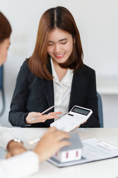 istock Agent explain house insurance contract to customer before sign in agreement contract at office. Real Estate concept. 1388580491