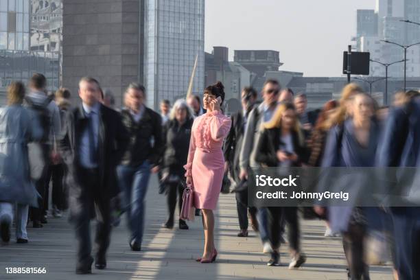 Executive Dressed In Pink Using Phone During Morning Commute Stock Photo - Download Image Now
