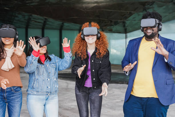 istock Young people having fun using virtual reality goggles outdoor 1388584444