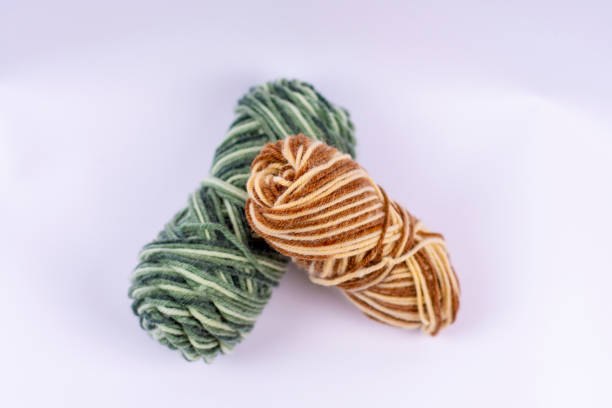istock Skeins of multi-colored woolen threads for knitting on a light background. Hobby accessories during boring quarantine at home. 1388586097