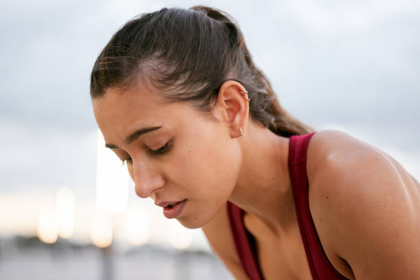 istock Shot of a young woman taking a break while on a run outside 1388588015