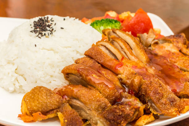 Traditional chinese roasted braised duck (shao ya) served with white rice and vegetables