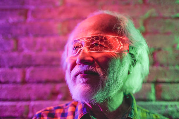 istock Asian senior man using virtual reality glasses indoor - Elderly person having fun with modern technology 1388594300
