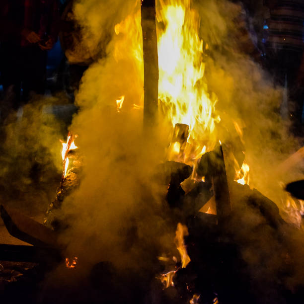 istock Fire flames on black background, Blaze fire flame texture background, Beautifully, the fire is burning, Fire flames with wood and cow dung 1388594583
