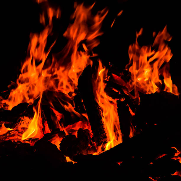 istock Fire flames on black background, Blaze fire flame texture background, Beautifully, the fire is burning, Fire flames with wood and cow dung 1388594604