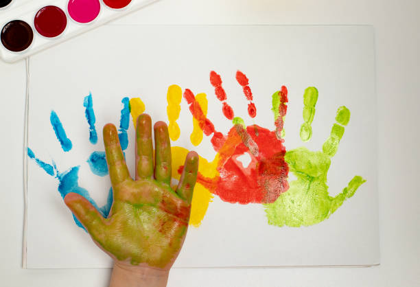 istock close-up hand, colored palm prints on white paper, creative creativity concept, fine motor skills, patience and perseverance 1388595799