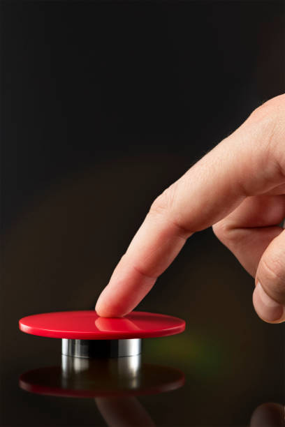 istock A man's hand presses a big red button. Red button on a dark background. The threat of using nuclear or chemical weapons of mass destruction. Rocket launch at the push of a button 1388596697