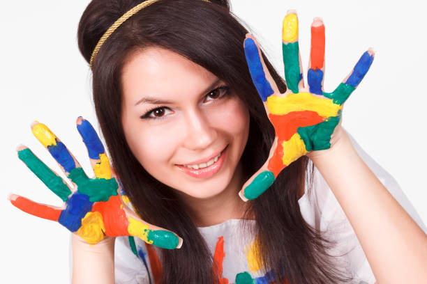 istock young woman with hands painted with colorful paints, ready for handprints. 1388597919