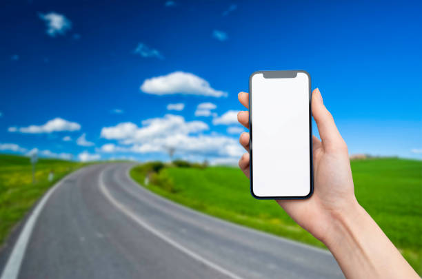 istock Hand holds blank mobile phone in nature 1388598322