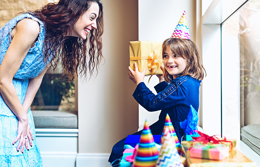 Happy little girl celebrating a birthday with family