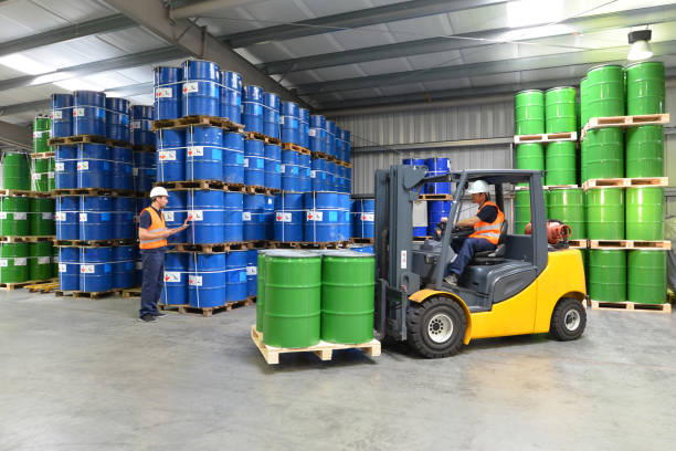 gruppo di lavoratori nel settore della logistica lavorano in un magazzino con prodotti chimici - carrello elevatore - industria chimica foto e immagini stock