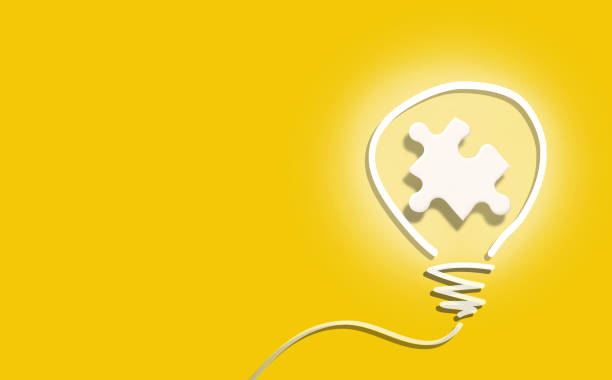 istock Light bulb idea with white jigsaw on yellow background 1388599623
