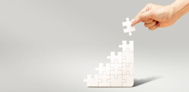 istock Hand fill white jigsaw puzzle to fulfill the puzzle 1388599681