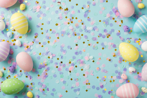 istock Top view photo of easter decorations different color easter eggs gold pink and lilac confetti on isolated pastel blue background 1388602332