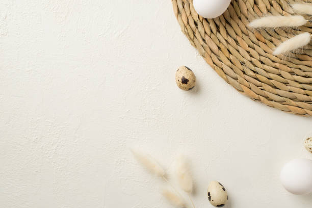 istock Top view photo of easter decorations lagurus flowers round serving mat and easter eggs on isolated white background with empty space 1388602380