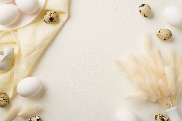 istock Top view photo of easter decorations white vase with lagurus flowers plate ceramic rabbit quail eggs and cloth on isolated white background with copyspace 1388602418
