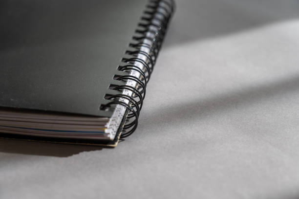 istock Black spring-loaded notebook against a gray background. Close-up of a closed notebook. 1388603509