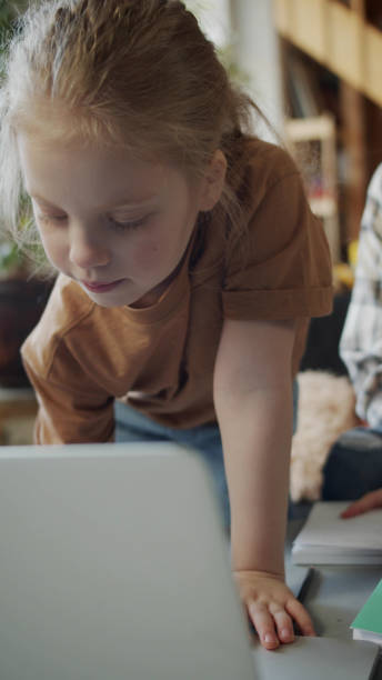 istock Mom and daughter use laptop to do homework 1388609401