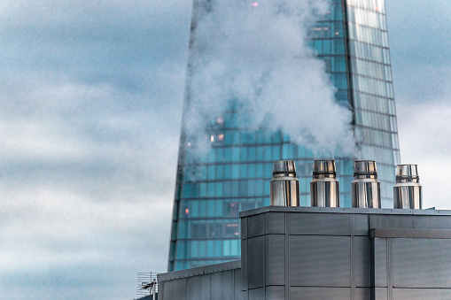 Flue chimney fixed to building exterior wall stainless steel from exhaust boiler plant room UK