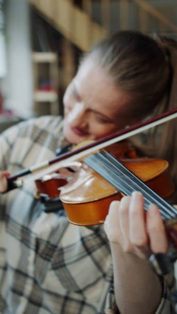 istock A child studies with a violin tutor in a spacious living room 1388610271