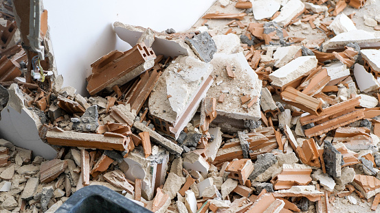 Pile of construction waste after wall demolition in an apartment during remodeling