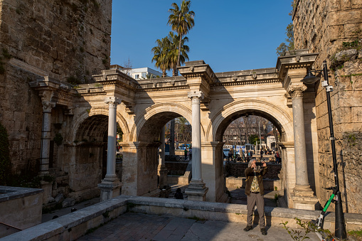 The monumental triumphal arch was built on the city wall in 130 in honor of the Roman Emperor Hadrian's visit to Antalya.man in his 60s with long white hair