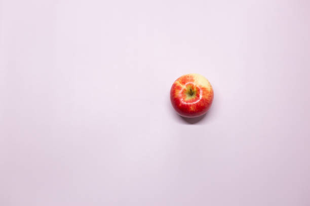 istock A red apple lies on a purple background 1388612143