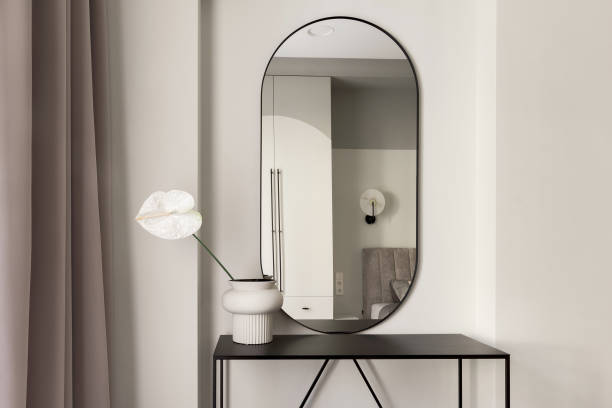 istock Single white Anthurium flower in ceramic vase on metal black console table in bedroom interior. Modern interior decoration concept. 1388612419