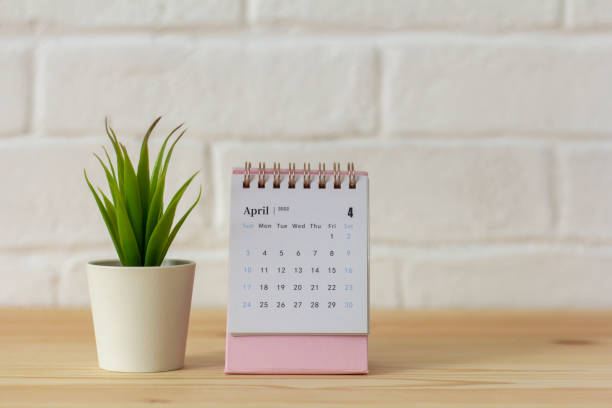 istock Desktop calendar for April 2022 for planning on the table. 1388612731