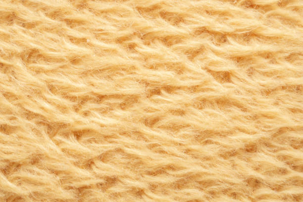 istock yellow fluffy fur fabric wool texture background 1388613126