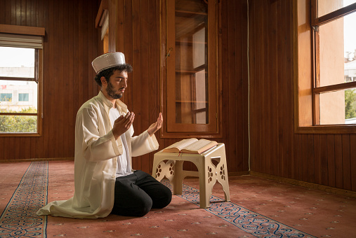 Muslims praying in mosque.