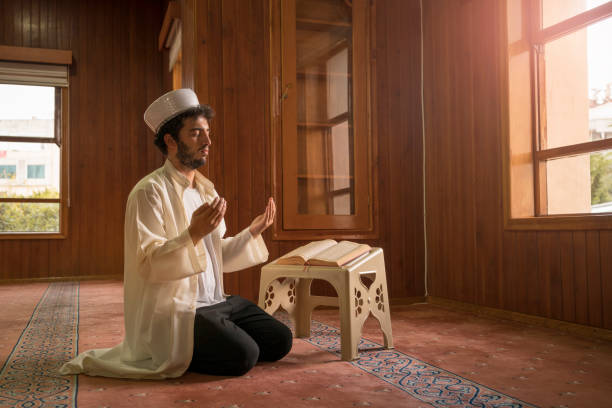istock Muslims praying in mosque. 1388619282
