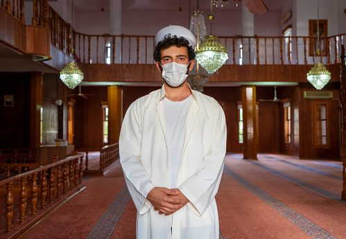 Portrait of mosque imam wearing protective face mask.