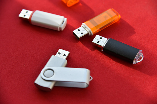 Various USB flash drives on a red background