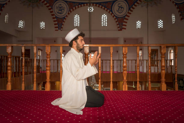 Muslim man praying in mosque.