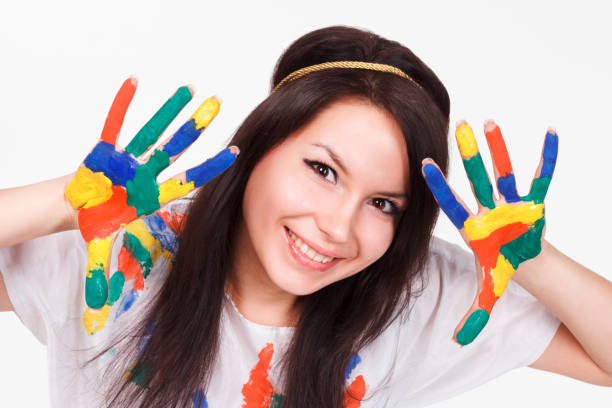 istock young woman with hands painted with colorful paints, ready for handprints. 1388625907