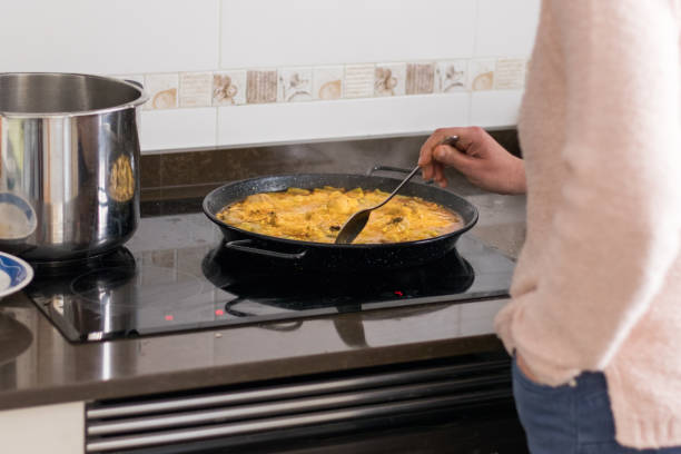 istock woman making paella at home 1388627084