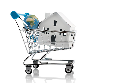 Shopping new homes around the world. Little planet Earth, house and shopping cart on white background. Conceptual image about the search for a new home around the world, those displaced by wars, politics and the poor economies of the countries.
Visual references from NASA (https://visibleearth.nasa.gov/images/74117/august-blue-marble-next-generation).