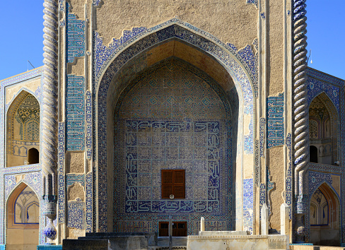 Balkh, Balkh province, Afghanistan: Green Mosque - 15th century Timurid Architecture, built by the ruler of the Eastern Timurid Empire, Shah Rukh - tiled iwan and pishtak framed by Solomonic pilasters, decorated with intricate Persian tiles with geometric motives and Koranic verses, the dilapidated tiles reveal the masonry structure - Masjid Sabz, Sufi Shrine of Khwaja Abu Nasr Parsa.