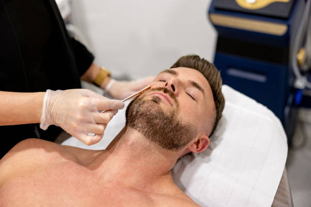 istock Man at the spa waxing his beard 1388628686