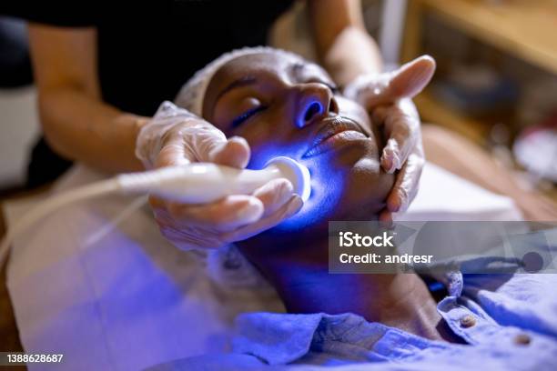 Woman At The Spa Getting A Rejuvenation Treatment On Her Face Stock Photo - Download Image Now