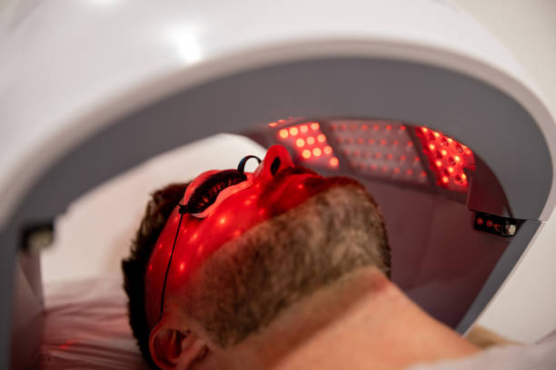 Man at a spa getting a light therapy treatment Man at a spa getting a light therapy treatment - beauty concepts light therapy stock pictures, royalty-free photos & images