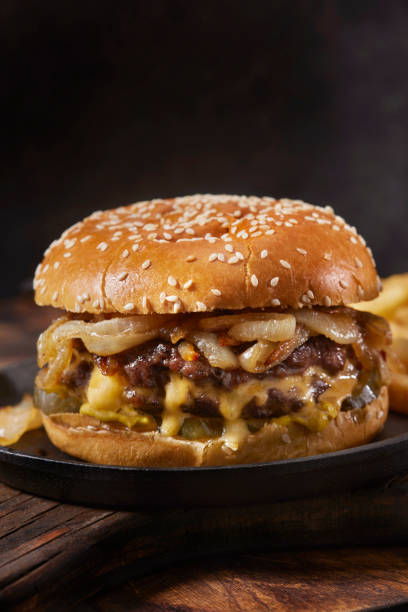 the juicy lucy stuffed cheeseburger with fried onions - sesame bun american culture cheddar imagens e fotografias de stock